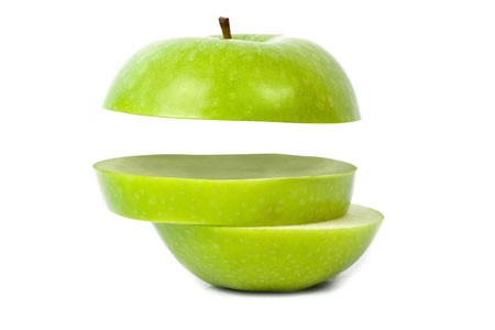 Photo of a sliced green apple.