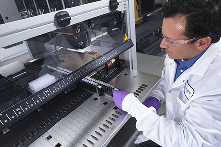 Covance scientist analyzing a sample in a lab. Drug analysis services.