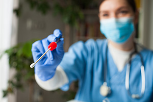 Photo of a doctor holding a swab