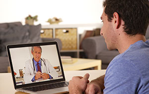 photo of a patient talking to a doctor on a computer