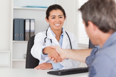photo of a doctor shaking hands with a patient
